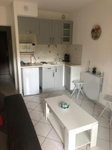a kitchen with a white table in a room at Cannes center in Cannes