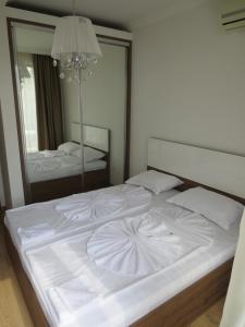 Postel nebo postele na pokoji v ubytování PORTO PARADISO Apart Complex