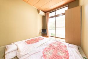 Postel nebo postele na pokoji v ubytování Tabist Watanabe Chiba Ichinomiya
