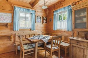 a dining room in a cabin with a table and chairs at Alpine Cabin in Klippitztorl