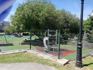 a playground in a park next to a light pole at Albergue Camiño Real in Sigüeiro