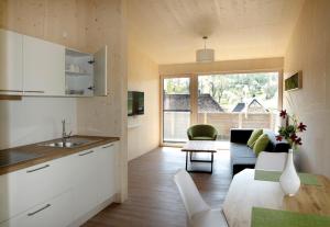 a kitchen and living room with a couch and a table at Steigerwald-Apartments in Ebrach