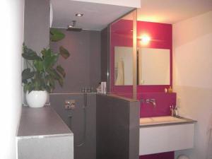 a bathroom with a sink and a tub and a mirror at Appartement am Salamanderpark in Kornwestheim