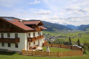 a house with a fence and mountains in the background at Haus Obermoser in Flachau