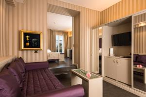 a hotel room with a couch and a bedroom at Villa Nicolli Romantic Spa Resort - Adults Only in Riva del Garda