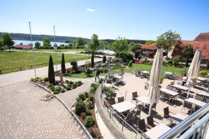 a view of a patio with umbrellas and chairs at Cafe-Restaurant Zum Hochreiter in Spalt