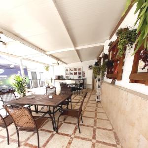 un patio extérieur avec des tables, des chaises et un comptoir dans l'établissement Hostal Kokkola, à Fuengirola