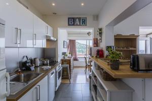 a kitchen with a sink and a counter top at MY CASA - VILLEFRANCHE CAUVIN - Panoramic Sea View AC in Villefranche-sur-Mer