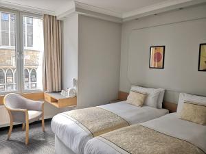 Säng eller sängar i ett rum på Lancaster Hall Hotel
