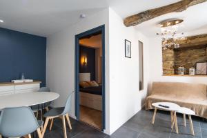 a room with a table and chairs and a bed at Résidence du Pélican in Lannion
