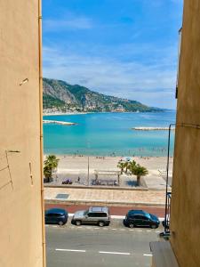 a view of a beach from a window of a building at Les Sablettes in Menton