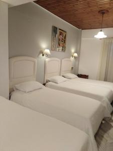 A bed or beds in a room at Kouros Hotel