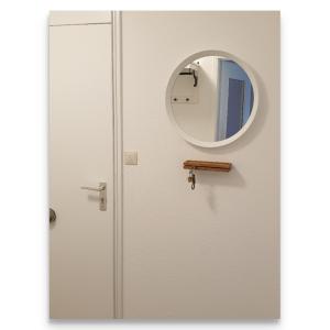 a door with a round mirror on it at Harz Zeit in Altenau