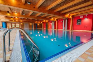 a large indoor swimming pool with a slide at Park Holiday Congress & Wellness Hotel in Prague