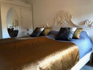 a bedroom with a large bed with a large mirror at De Heidehoeve in Wezep +18 photos