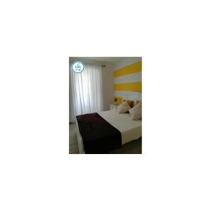 um quarto com uma cama e um espelho em Casa da Avó Lucinda na Nazaré