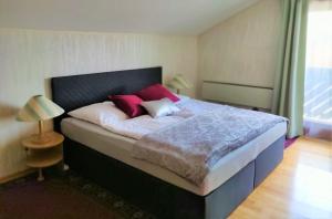 a bedroom with a large bed with red pillows at Haus zum Wohlfühlen in Vienna