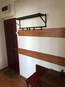 a room with a door and a shelf on the wall at Sara Apartman in Târgu-Mureş +6 photos