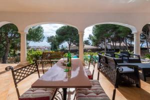 una mesa y sillas en un patio con vistas en Villa Luxury en Binibeca