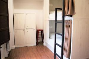 a room with a wooden floor and a door leading to a room with a at Hostel Quartier Leon Jabalquinto in León