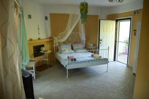 a bedroom with a bed with a canopy at PortoAgali in Porto Koufo
