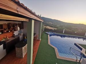 a house with a swimming pool on the side of it at Yiannos House in Evrykhou