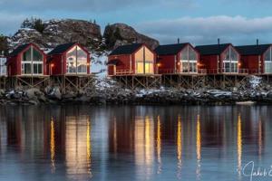 a row of houses on the shore of the water at Fisherman`s Cabin Lofoten in Ballstad