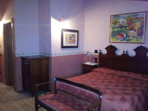 a bedroom with a bed and a chair in it at Casa del Contrabbandiere in Pozzolengo