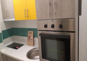 a kitchen with a stove and a sink at Lux Apartment in the city center in Štip