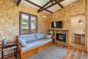 a living room with a couch and a fireplace at Casa do Monte da Veiga - Minho's Guest in Póvoa de Lanhoso