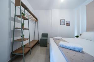 a bedroom with a bed with a ladder next to it at Hermes Design Suites in Iraklitsa
