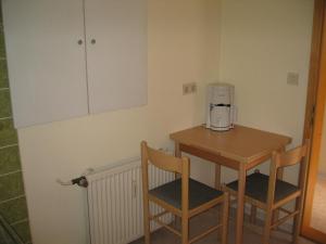 a small table with two chairs and a coffee maker on it at Ferienwohnung Waschinski in Goslar