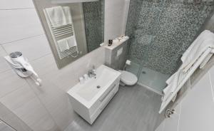 a bathroom with a sink and a toilet and a mirror at Villa Dalmatia Apartments in Brela +54 photos