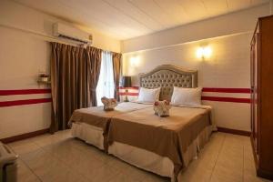 Postel nebo postele na pokoji v ubytování SUDYOD HOTEL