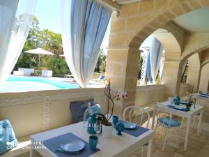 a dining room with a view of a swimming pool at B&B Tenuta Martinelli in Monopoli