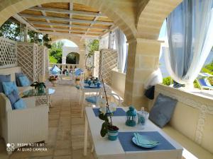 an outdoor patio with tables and chairs and windows at B&B Tenuta Martinelli in Monopoli
