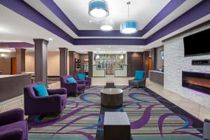 a lobby with purple chairs and a fireplace at La Quinta by Wyndham Pasadena North in Pasadena
