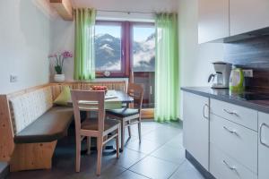 een keuken met een tafel en stoelen en een raam bij Hofschenke Pfeiftal - Bergwiese in San Martino