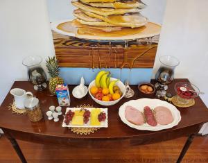 a table with food on it with a plate of fruit at The Jane Toronto in Toronto