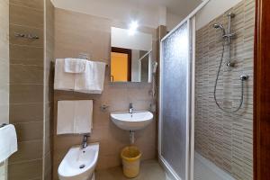 a bathroom with a sink and a toilet and a shower at Il Nocchiero City Hotel in Soverato Marina