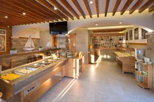 a large kitchen with a counter and a kitchenasteryasteryasteryasteryasteryasteryastery at Villa Ljubanovic in Budva