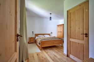 a bedroom with a bed and an open door at Anahouse in Vişeu de Sus
