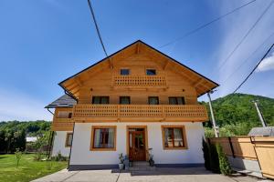 une maison avec un toit en bois dans l'établissement Anahouse, à Vişeu de Sus