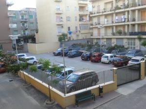 a parking lot with cars parked in front of a building at Il Nocchiero City Hotel in Soverato Marina