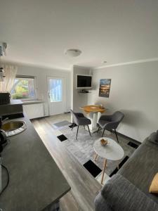 a living room with a couch and chairs and a table at Ferienwohnung Lorenz in Korswandt