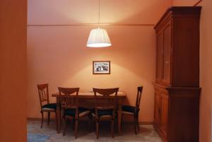 a dining room table with chairs and a lamp at Central Apartments Lviv in Lviv
