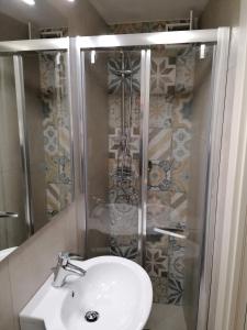 a bathroom with a sink and a shower at Alimarta in Monopoli +20 photos
