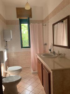 a bathroom with a toilet and a sink at Tenuta Punta della Suina in Gallipoli +32 photos