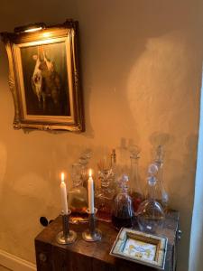 a table with candles and a picture of a dog at L'aile du Chateau in Ramatuelle +35 photos