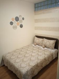 a bedroom with a bed with a comforter at GRAND Jagodina in Jagodina